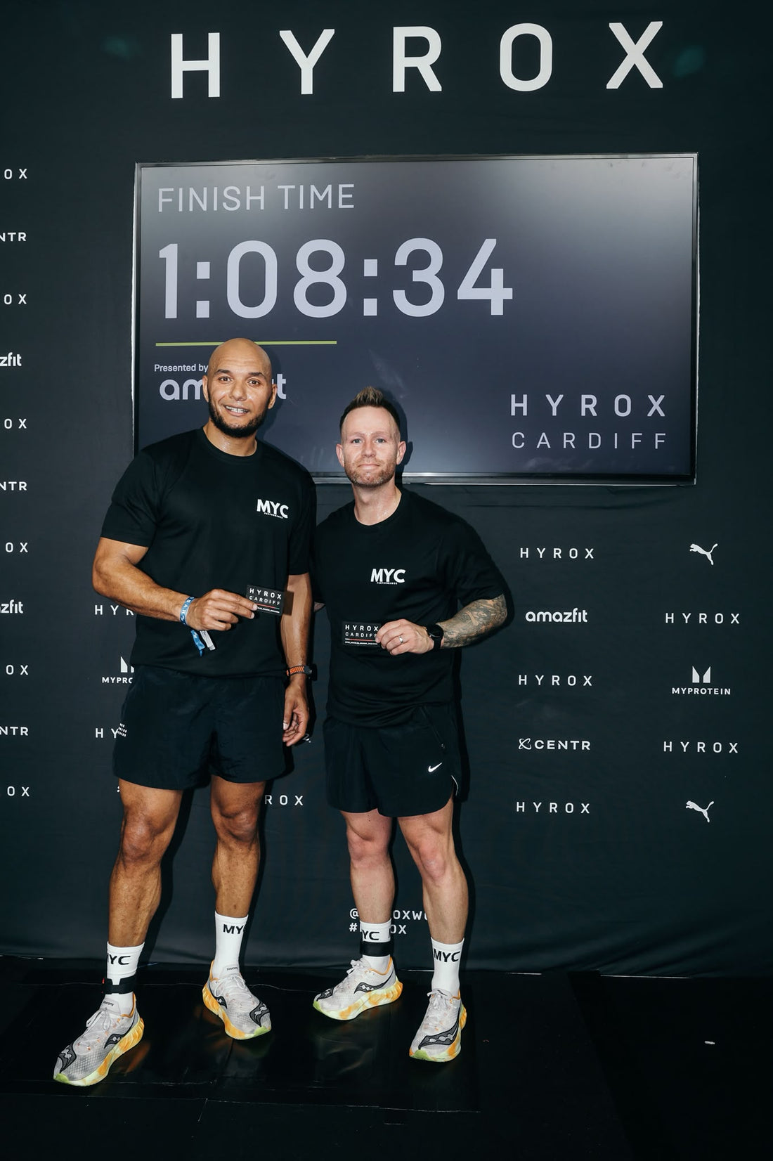 MYC co-owners Adam Griffiths and Matthew Vaughan at the HYROX Cardiff finish line, both in MYC kit and MYC socks